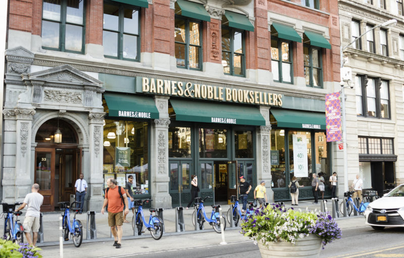 A Barnes and Noble store across the street from Union Square Park. People can be seen.