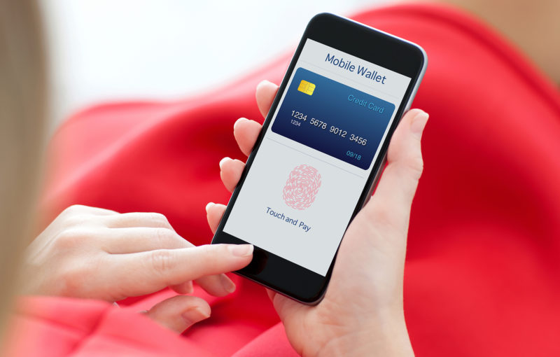 woman in red dress holding a phone with app mobile wallet and fingerprint for online shopping