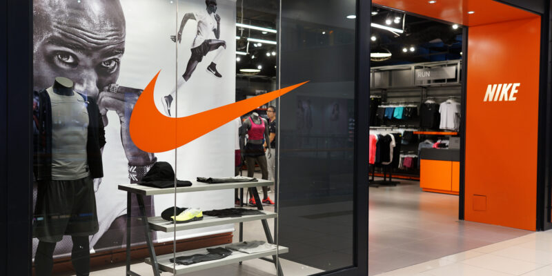 Black grey and orange photo of the front of a Nike store entrance