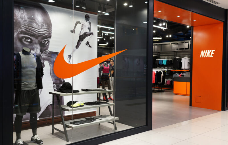 Black grey and orange photo of the front of a Nike store entrance