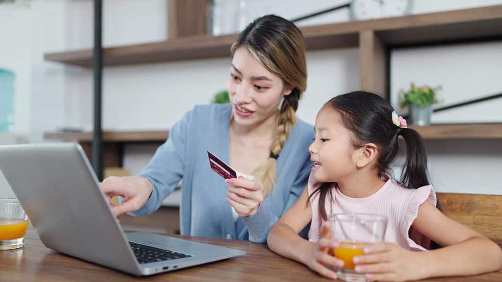 Mother and daughter learning about online banking and finance together