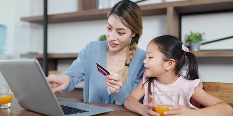 Mother and daughter learning about online banking and finance together