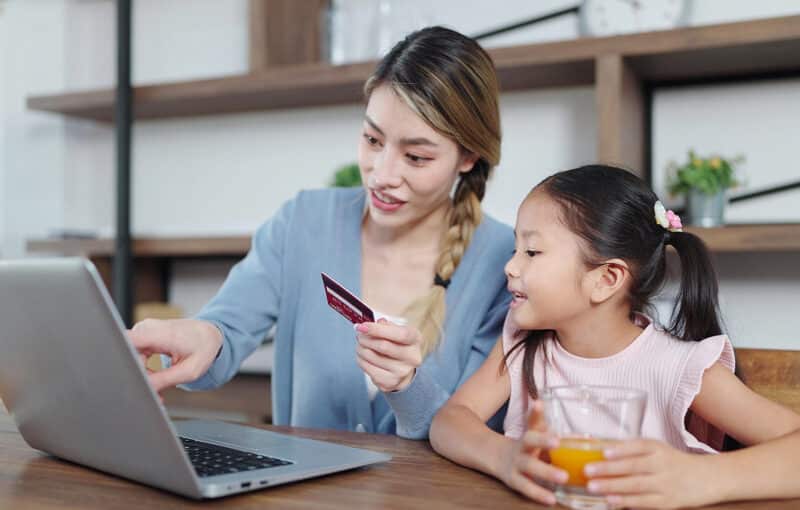 Mother and daughter learning about online banking and finance together